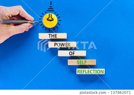 Self reflection symbol. Concept words The power of self reflection on beautiful wooden blocks. Beautiful blue background. Businessman hand. Business the power of self reflection concept. Copy space. Self reflection symbol. Concept words The power of self reflection on beautiful wooden blocks. Beautiful blue background. Businessman hand. Business the power of self reflection concept. Copy space. 137862071