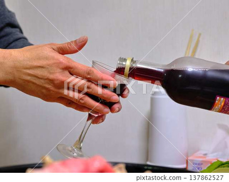 A woman poured wine A woman poured wine 137862527