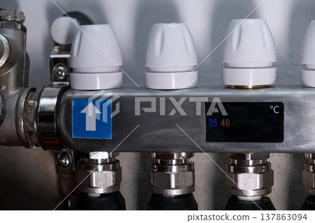 Complex residential heating manifold system with valves, gauges, and piping network Complex residential heating manifold system with valves, gauges, and piping network 137863094
