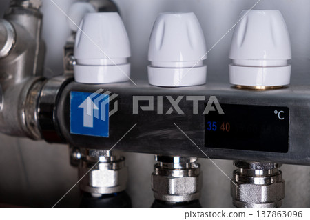 Complex residential heating manifold system with valves, gauges, and piping network Complex residential heating manifold system with valves, gauges, and piping network 137863096