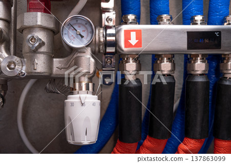 Complex residential heating manifold system with valves, gauges, and piping network Complex residential heating manifold system with valves, gauges, and piping network 137863099