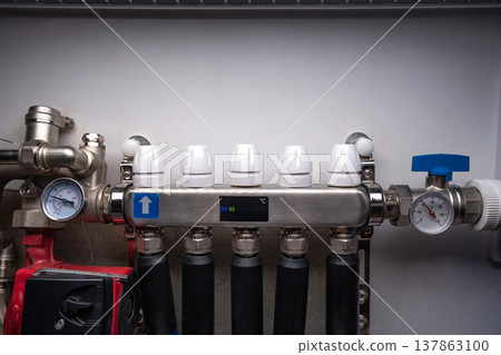 Complex residential heating manifold system with valves, gauges, and piping network Complex residential heating manifold system with valves, gauges, and piping network 137863100