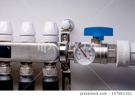 Complex residential heating manifold system with valves, gauges, and piping network 137863101