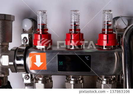 Complex residential heating manifold system with valves, gauges, and piping network Complex residential heating manifold system with valves, gauges, and piping network 137863106