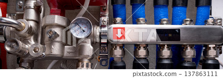 Complex residential heating manifold system with valves, gauges, and piping network. banner Complex residential heating manifold system with valves, gauges, and piping network. banner 137863111