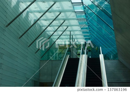 The escalator hall of the museum, with its beautiful geometric glass and light. The escalator hall of the museum, with its beautiful geometric glass and light. 137863196