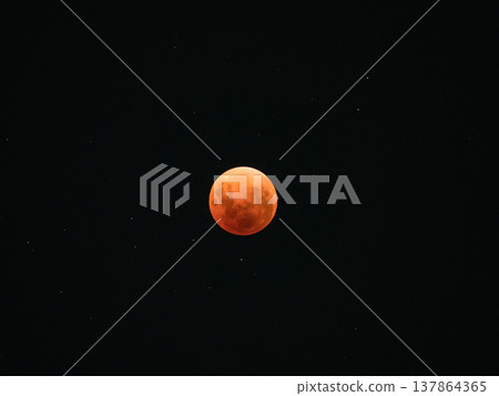 A blood moon, stained red by a total lunar eclipse, and the celestial landscape of the starry sky. 137864365