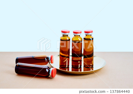 Vials on tray containing brown liquid medicine Vials on tray containing brown liquid medicine 137864440