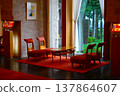 The elegant hotel lounge features a harmonious blend of red carpet and stone walls. 137864607