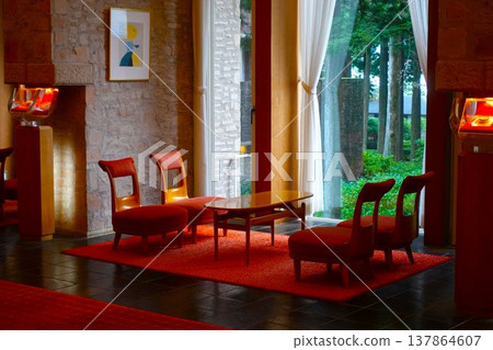 The elegant hotel lounge features a harmonious blend of red carpet and stone walls. The elegant hotel lounge features a harmonious blend of red carpet and stone walls. 137864607