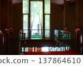 The hotel's stairwell is elegant, with stone walls and red accents. 137864610