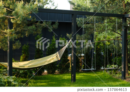Relaxing space with hammock and swings in a garden setting during sunny daytime 137864613