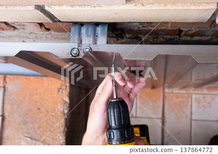 Repair of the foundation and walls of the house with the installation of metal sheets on the frame for finishing the basement. Repair of the foundation and walls of the house with the installation of metal sheets on the frame for finishing the basement. 137864772