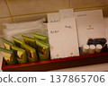 A set of high-quality amenities neatly arranged on the bathroom counter of a luxury hotel. 137865706