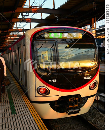 Keio 2000 series train, set 2701F, illuminated by the setting sun at Takahatafudo Station. Keio 2000 series train, set 2701F, illuminated by the setting sun at Takahatafudo Station. 137865976