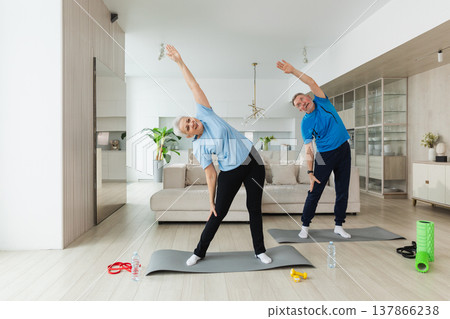 Fitness training. Senior mature healthy fit couple doing sports exercise at home. Mid age husband wife have training workout. Health care healthy lifestyle. Workout rehabilitation for old man woman Fitness training. Senior mature healthy fit couple doing sports exercise at home. Mid age husband wife have training workout. Health care healthy lifestyle. Workout rehabilitation for old man woman 137866238