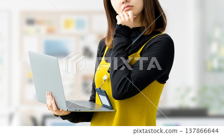 A woman/businesswoman thinking with a laptop A woman/businesswoman thinking with a laptop 137866644