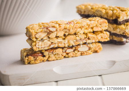 Crunchy Peanut Brittle Nut Bars Stacked On A Cutting Board For Sweet Snack Time Crunchy Peanut Brittle Nut Bars Stacked On A Cutting Board For Sweet Snack Time 137866669