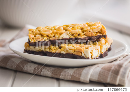 Stacked Peanut Granola Bars With Chocolate Coating On Plate, Crunchy Snack Food Stacked Peanut Granola Bars With Chocolate Coating On Plate, Crunchy Snack Food 137866673