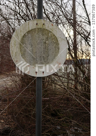 Old Weathered Blank Round Road Sign in Forest 137867389