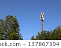 A tall tower with a cell phone antenna on top 137867394