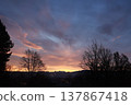 Dramatic Sunset Over Silhouetted Mountain Range and Trees 137867418