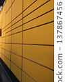 A yellow wall with a lot of vertical lines 137867456