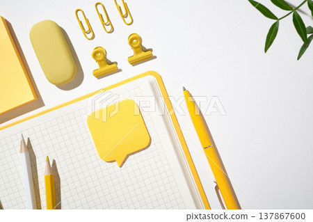 Minimalist workspace arrangement with scissors, pencils, and clips on a white background. Copyspace 137867600