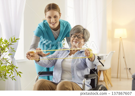 Woman carer nurse physiotherapist helps senior woman with physical health problems 137867607