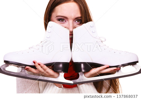 Smiling woman with ice skates Smiling woman with ice skates 137868037