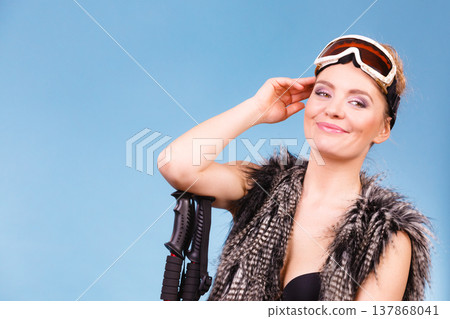 Sexy woman holding ski poles 137868041