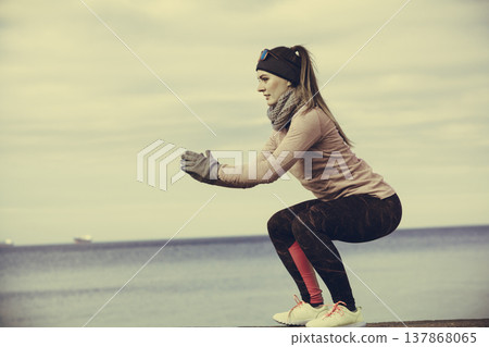 Woman fitness sport girl training outdoor in cold weather Woman fitness sport girl training outdoor in cold weather 137868065