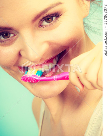 Woman brushing cleaning teeth 137868078