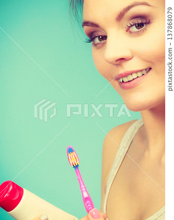 Woman holds toothbrush and paste for teeth cleaning 137868079