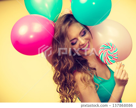 Woman with colorful balloons and lollipop Woman with colorful balloons and lollipop 137868086