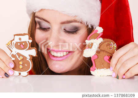 Woman santa claus hat with gingerbread cookies. Christmas Woman santa claus hat with gingerbread cookies. Christmas 137868109
