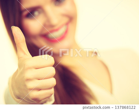 Happy positive brunette woman showing thumb up Happy positive brunette woman showing thumb up 137868122