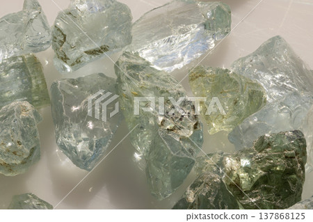 Raw Aquamarine Gemstones Displayed With Natural Green And Blue Hues On White Background For Jewelry Design Inspiration Raw Aquamarine Gemstones Displayed With Natural Green And Blue Hues On White Background For Jewelry Design Inspiration 137868125