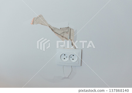 Damaged White Wall With Peeling Paint Around Electrical Outlet Showing Cracks And Exposed Plaster In Neutral Tone Interior Scene 137868140
