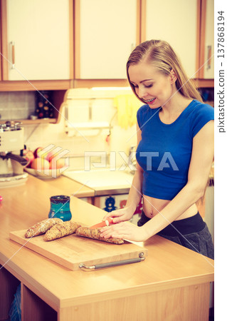 Woman preparing healthy breakfast making sandwich 137868194