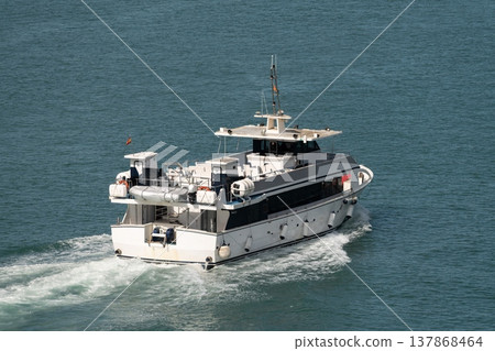 White passenger vessel cruising on calm sea White passenger vessel cruising on calm sea 137868464