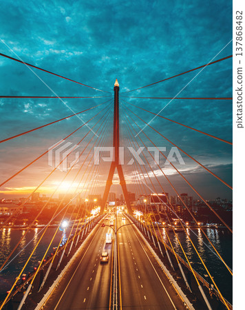 symmetric modern cable-stayed Rama VIII bridge over Chao Phraya river in Bangkok, symmetry perspective of contemporary suspension urban span connecting city skyline across Thai waterway symmetric modern cable-stayed Rama VIII bridge over Chao Phraya river in Bangkok, symmetry perspective of contemporary suspension urban span connecting city skyline across Thai waterway 137868482