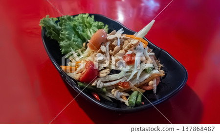 Thai green papaya salad som tam with peanuts vegetables, Spicy fresh shredded papaya dish tomatoes beans chili Thai green papaya salad som tam with peanuts vegetables, Spicy fresh shredded papaya dish tomatoes beans chili 137868487