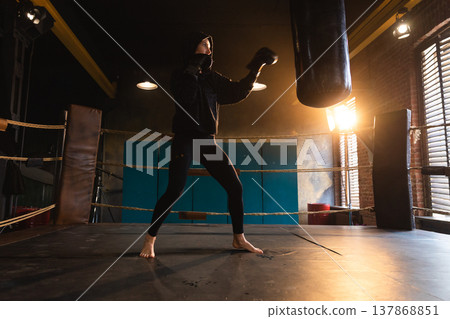 Women self defense girl power. Strong woman fighter training punches on boxing ring. Healthy strong girl punching boxing bag. Training day in boxing gym. Strength fit body workout training Women self defense girl power. Strong woman fighter training punches on boxing ring. Healthy strong girl punching boxing bag. Training day in boxing gym. Strength fit body workout training 137868851