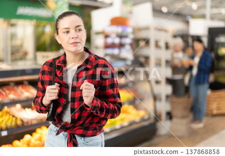 Young woman choosing food in grocery store Young woman choosing food in grocery store 137868858