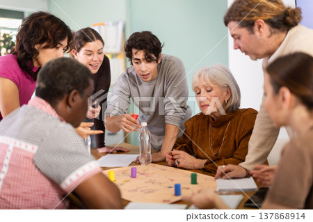 Group of different ages playing board game at table Group of different ages playing board game at table 137868914