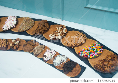 Traditional waffles with multicolored toppings to sell 137868935