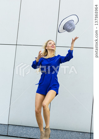 Fashion model throwing hat Fashion model throwing hat 137868964