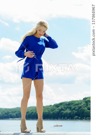 Fashion model wearing blue jumpsuit 137868967