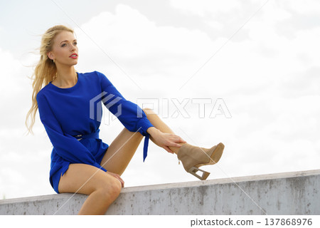 Fashion model wearing blue jumpsuit Fashion model wearing blue jumpsuit 137868976